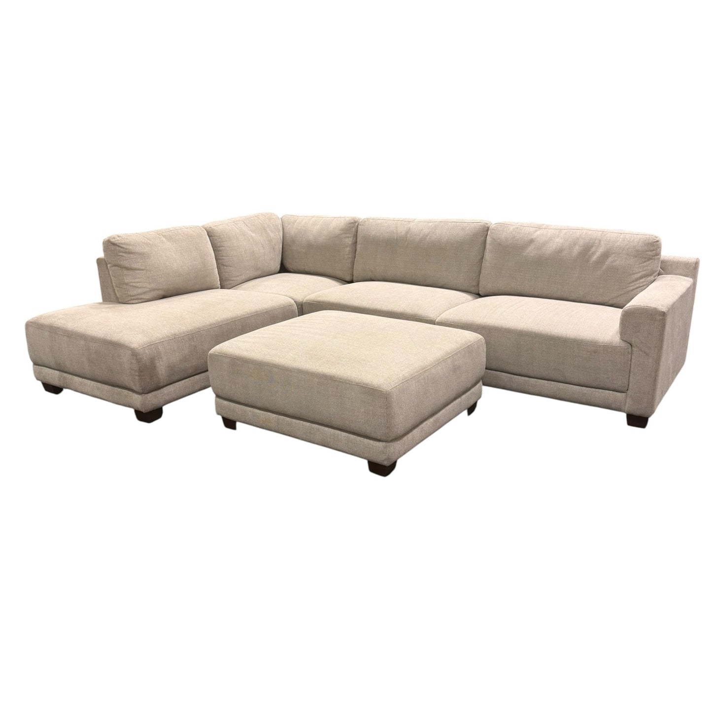 Couch Quest light beige modular sectional sofa with matching ottoman and dark low-profile feet on white background